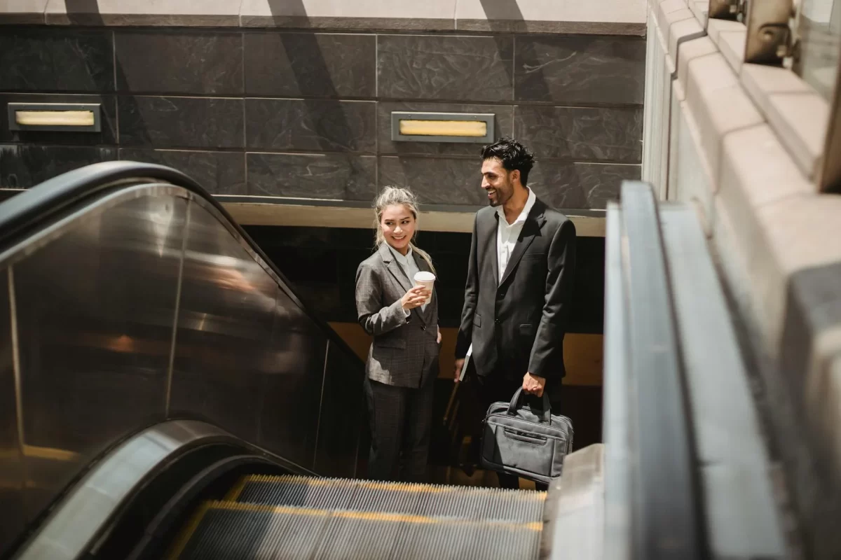 Return to the Office - man and woman standing on escalator