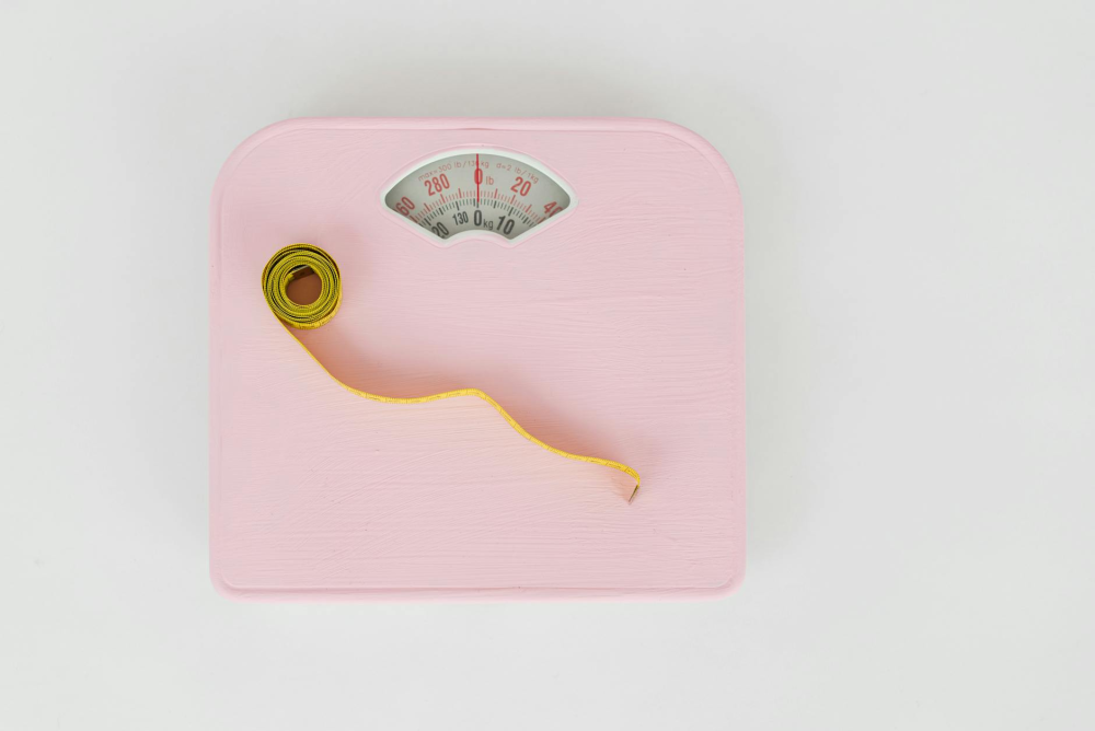 lose 30 pounds - measuring tape on a weighing scale